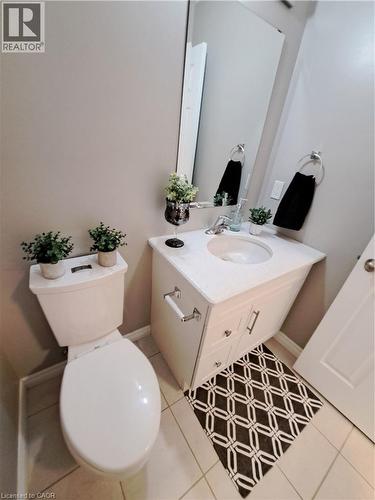 Bathroom featuring a white vanity with a built-in sink, chrome fixtures, and a wall-mounted mirror - 26 Wheat Lane, Kitchener, ON - Indoor Photo Showing Bathroom