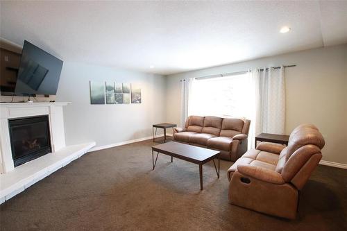Living Room with Propane Fireplace - 77 Guymer Crescent, The Pas, MB - Indoor Photo Showing Living Room With Fireplace