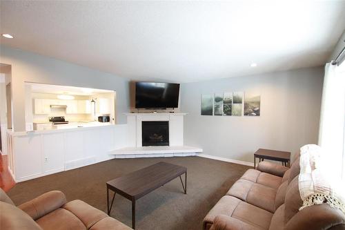 Living Room with Propane Firepalce - 77 Guymer Crescent, The Pas, MB - Indoor Photo Showing Living Room With Fireplace