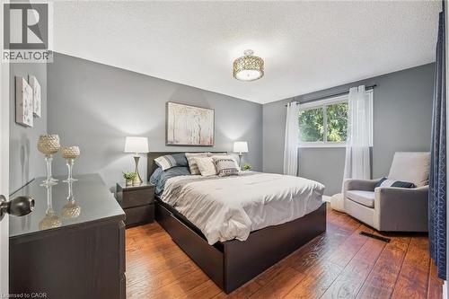 Wood-finish flooring, recessed window, and overhead decorative lighting fixture - 460 Parkview Crescent, Cambridge, ON - Indoor Photo Showing Bedroom