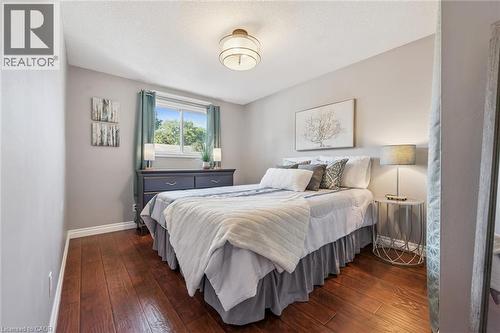 Hardwood-finish flooring, neutral wall tones, window with natural light, and a flush-mount ceiling fixture - 460 Parkview Crescent, Cambridge, ON - Indoor Photo Showing Bedroom
