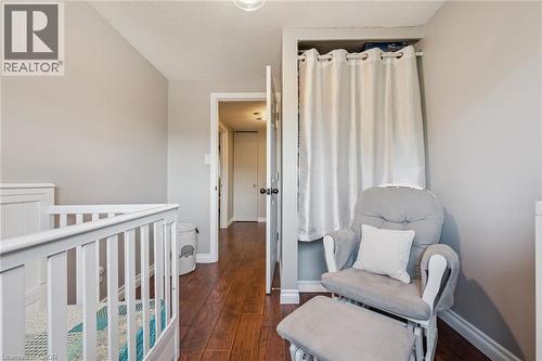 Hardwood flooring with a matte finish, light grey wall paint, and a built-in open closet space - 460 Parkview Crescent, Cambridge, ON - Indoor Photo Showing Bedroom