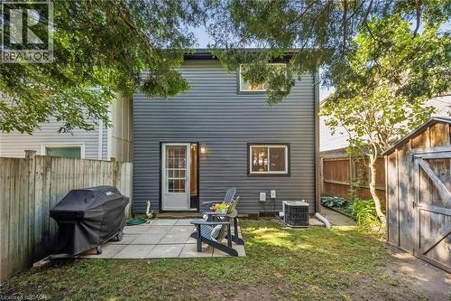 Rear exterior with gray siding, ground-level patio, and wood fencing - 460 Parkview Crescent, Cambridge, ON - Outdoor With Exterior