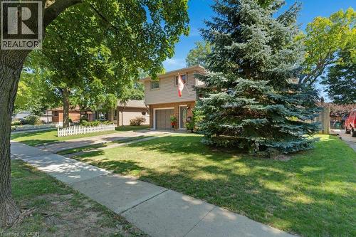 Two-story residence with brick and siding exterior, attached garage, and a concrete driveway - 236 Winston Boulevard, Cambridge, ON - Outdoor