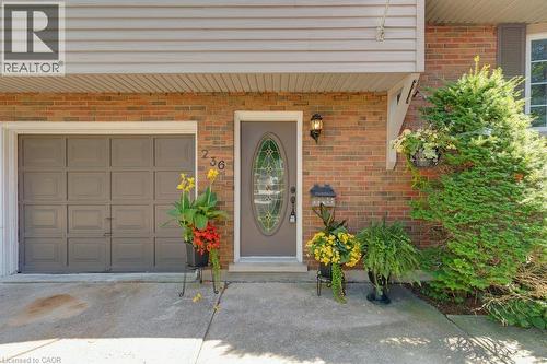 Brick exterior with neutral siding and an integrated garage - 236 Winston Boulevard, Cambridge, ON - Outdoor With Exterior