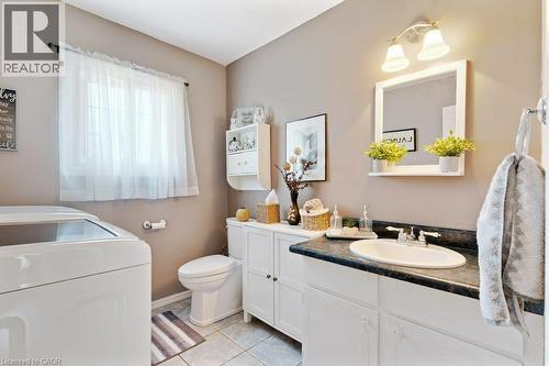 Spa-inspired bathroom featuring a white vanity with dual rectangular vessel sinks, black countertop surface, and chrome fixtures - 236 Winston Boulevard, Cambridge, ON - Indoor Photo Showing Bathroom