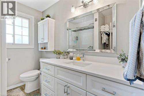 White vanity with integrated sink, sleek quartz countertop, and chrome hardware - 236 Winston Boulevard, Cambridge, ON - Indoor Photo Showing Bathroom