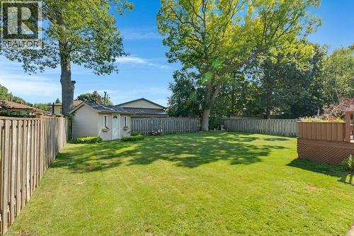Expansive lawn area, perimeter fencing, mature trees, storage shed, and a composite deck with lattice skirting - 236 Winston Boulevard, Cambridge, ON - Outdoor With Backyard