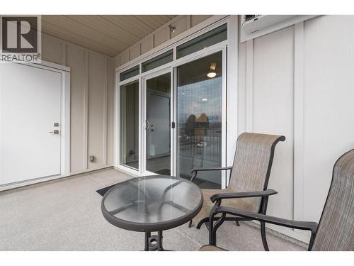 Nice size deck with sliding patio door to allow full use of the space.  Note: Additional full size storage room behind the door!  In addition to a same floor storage room beside the unit. - 3090 Burtch Road Unit# 201, Kelowna, BC - Indoor Photo Showing Living Room