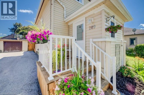 Front entrance featuring light-colored siding and white railings - 209 Belleview Avenue, Kitchener, ON - Outdoor With Deck Patio Veranda