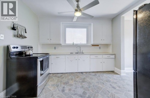 Kitchen featuring white cabinetry, a stainless steel sink, and a window with blinds - 209 Belleview Avenue, Kitchener, ON - Indoor Photo Showing Kitchen With Double Sink