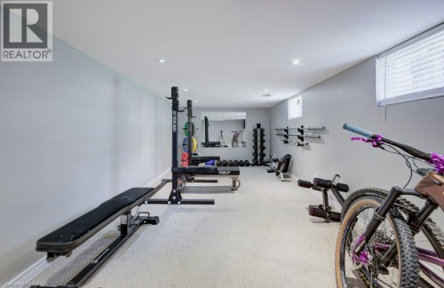 Finished basement space featuring recessed lighting, light-colored carpeting, and neutral wall tones - 209 Belleview Avenue, Kitchener, ON - Indoor Photo Showing Gym Room