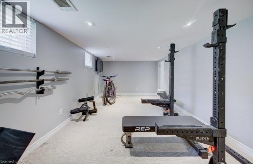 Recessed lighting illuminates the carpeted floor and light grey walls - 209 Belleview Avenue, Kitchener, ON - Indoor Photo Showing Gym Room