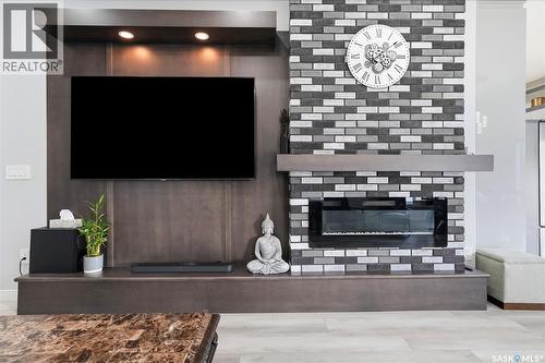 411 Schmeiser Bend, Saskatoon, SK - Indoor Photo Showing Other Room With Fireplace