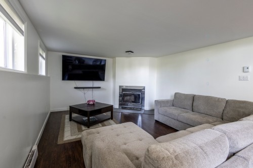 Salle familiale - 3013 Av. Bériot, Boisbriand, QC - Indoor Photo Showing Living Room With Fireplace