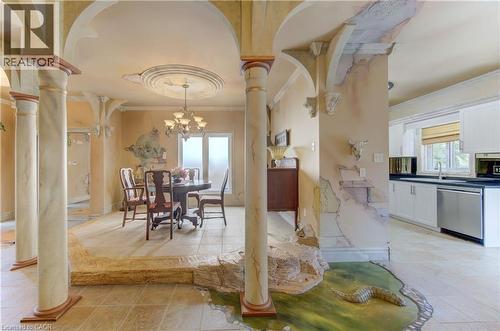 Tiled flooring featuring an integrated reptilian motif, arched doorways, and decorative columns - 74 Forest Edge Trail, Kitchener, ON 