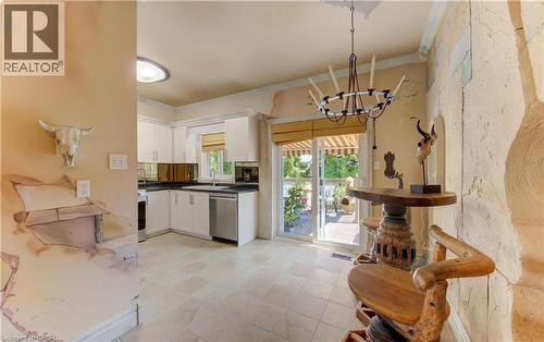 Kitchen featuring white cabinetry, dark countertops, and stainless steel appliances - 74 Forest Edge Trail, Kitchener, ON 