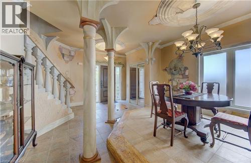 Entry foyer featuring Roman-inspired columns and a balustrade staircase - 74 Forest Edge Trail, Kitchener, ON 