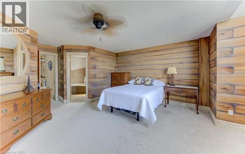 Carpeted room featuring wood-paneled walls and a ceiling fan - 74 Forest Edge Trail, Kitchener, ON 