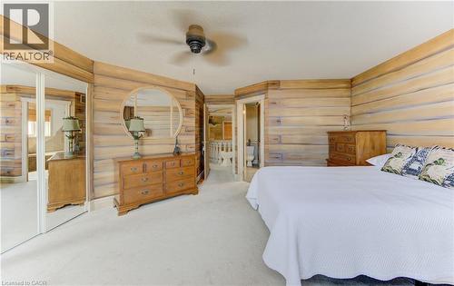Bedroom featuring light wood-finish paneled walls, a ceiling fan, and plush carpeting - 74 Forest Edge Trail, Kitchener, ON 