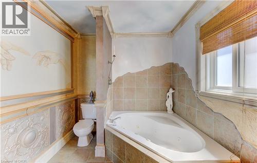 Spacious bathroom featuring a corner jetted soaking tub with tile surround - 74 Forest Edge Trail, Kitchener, ON 