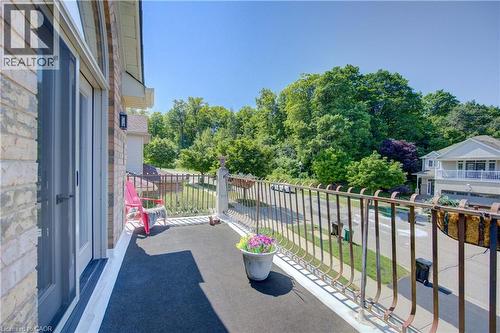 Exterior balcony featuring brick siding and a decorative metal railing - 74 Forest Edge Trail, Kitchener, ON 
