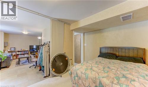 Recessed lighting illuminates the tiled flooring and neutral-toned walls throughout this adaptable interior space - 74 Forest Edge Trail, Kitchener, ON 