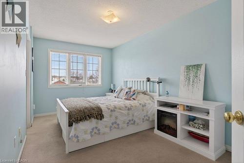 Soft blue wall paint with a textured ceiling - 10 Cadham Boulevard Unit# 29, Hamilton, ON - Indoor Photo Showing Bedroom