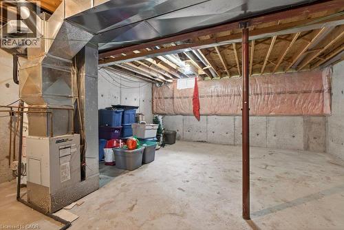 Unfinished basement with concrete flooring and exposed ceiling joists, featuring an HVAC system, galvanized ductwork, and concrete foundation walls - 10 Cadham Boulevard Unit# 29, Hamilton, ON - Indoor Photo Showing Basement