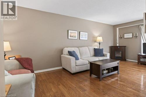 Hardwood flooring throughout, neutral paint colors, and a built-in fireplace - 10 Cadham Boulevard Unit# 29, Hamilton, ON - Indoor Photo Showing Living Room