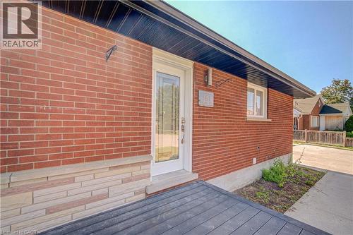 Brick exterior with stacked stone accent, dark soffit, and white window trim - 161 Kipling Avenue, Kitchener, ON - Outdoor With Exterior