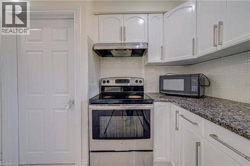 White cabinetry with brushed nickel hardware, stainless steel range, coordinating range hood, and a mosaic tile backsplash - 161 Kipling Avenue, Kitchener, ON - Indoor Photo Showing Kitchen