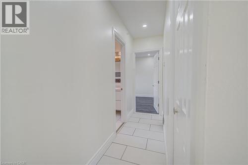 Corridor featuring rectangular tile flooring, recessed lighting, and white paneled doors - 161 Kipling Avenue, Kitchener, ON - Indoor Photo Showing Other Room