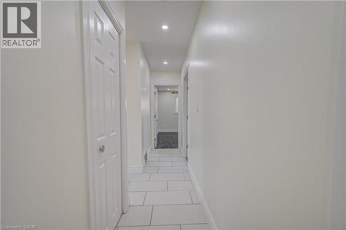 White tile flooring with light gray grout, recessed ceiling lighting, and a paneled interior door - 161 Kipling Avenue, Kitchener, ON - Indoor Photo Showing Other Room