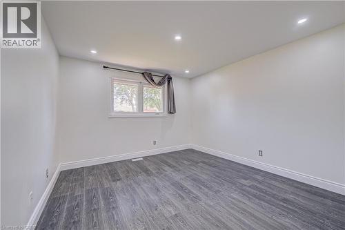 Recessed lighting, wood-finish flooring, white trim, and a window with a white frame - 161 Kipling Avenue, Kitchener, ON - Indoor Photo Showing Other Room