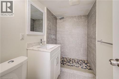 Vanity with a white finish, stone-finish countertop, and undermount sink - 161 Kipling Avenue, Kitchener, ON - Indoor Photo Showing Bathroom