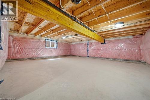 Unfinished basement featuring exposed wood joists, a prominent structural beam, concrete flooring, and insulated walls - 11 Ontario Street, Brantford, ON - Indoor Photo Showing Basement