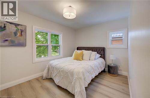 Recessed lighting, wood-finish flooring, white trim, and multiple windows - 34 Moore Avenue N, Waterloo, ON - Indoor Photo Showing Bedroom