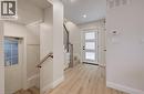 Light wood-finish flooring, staircase with wood handrail and black metal spindles, recessed ceiling lighting, and white interior doors - 34 Moore Avenue N, Waterloo, ON  - Indoor Photo Showing Other Room 
