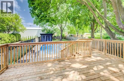 Expansive wooden deck with railing, stairs, and surrounding mature trees - 34 Moore Avenue N, Waterloo, ON - Outdoor With Deck Patio Veranda With Exterior