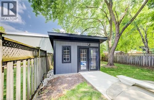 Shed with vertical siding, black trim, and a low-slope roof - 34 Moore Avenue N, Waterloo, ON - Outdoor