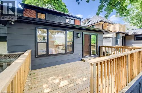 Expansive wooden deck with natural wood railing - 34 Moore Avenue N, Waterloo, ON - Outdoor With Deck Patio Veranda With Exterior