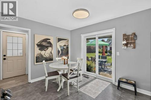 Gray-toned flooring, white trim, and a patio door providing direct outdoor access - 60 Elford Crescent, Hamilton, ON - Indoor Photo Showing Dining Room
