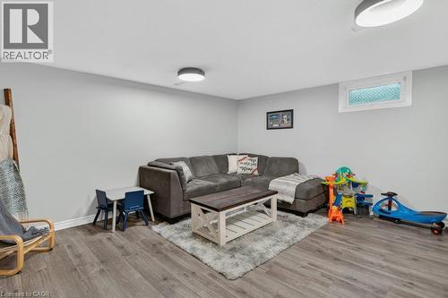 Recessed window, two flush-mount ceiling lights, wood-finish flooring, and light gray wall paint - 60 Elford Crescent, Hamilton, ON - Indoor