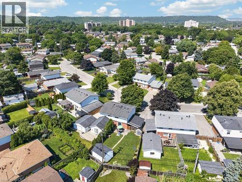 Aerial view showcasing a well-appointed residential property featuring a manicured lawn, mature landscaping, and multiple outbuildings on an expansive lot - 60 Elford Crescent, Hamilton, ON - Outdoor With View