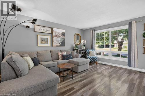 Bright, light-filled living room with expansive sliding glass doors and transom windows framing natural landscaping - 60 Elford Crescent, Hamilton, ON - Indoor Photo Showing Living Room