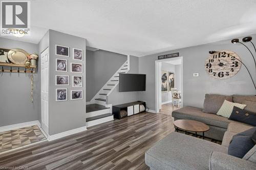 Wood-finish flooring throughout, with a contrasting patterned tile entry - 60 Elford Crescent, Hamilton, ON - Indoor Photo Showing Living Room