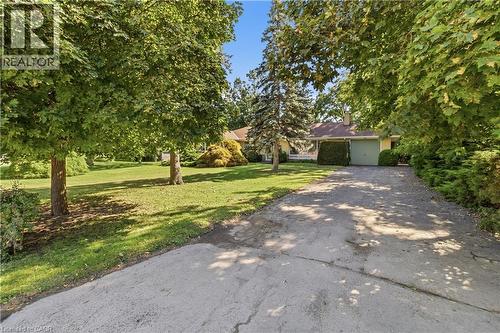 Brick ranch home situated on a mature, tree-lined lot with expansive lawn space - 974 Unsworth Avenue, Burlington, ON 