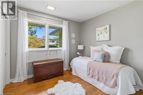 Room featuring wood-finish flooring, a double window with white trim, and light gray painted walls - 974 Unsworth Avenue, Burlington, ON 