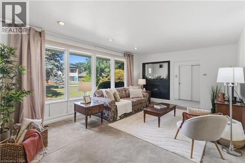 Bright and airy living room bathed in natural light from expansive multi-pane glass doors and windows overlooking manicured grounds - 974 Unsworth Avenue, Burlington, ON 
